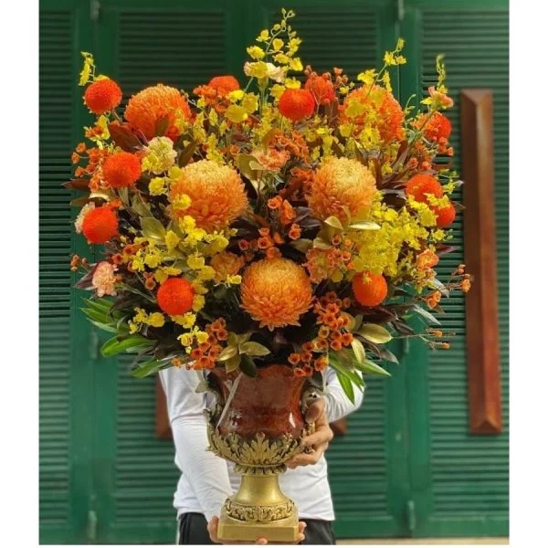 Thiet-ke-khong-ten-600x600.jpg.webp Hoa Tặng Năm Mới-Bình Hoa Màu Cam Sang Trọng - Image 1